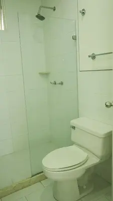 a white bathroom with a toilet and a shower at Morros 3 in Cartagena de Indias