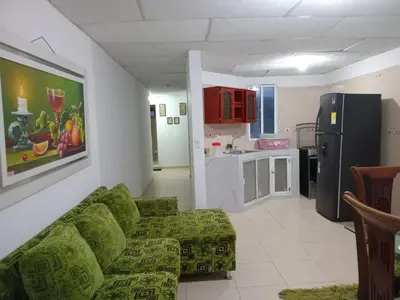 a living room with a couch and a kitchen at Rosymar in Cartagena de Indias