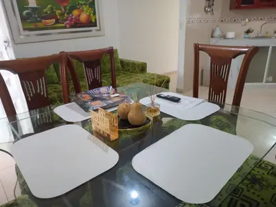 a living room with a glass table and chairs at Rosymar in Cartagena de Indias