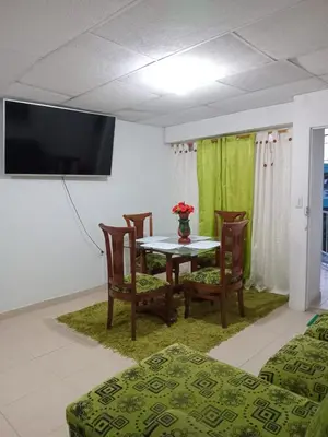 a dining room with a table and chairs and a tv at Rosymar in Cartagena de Indias