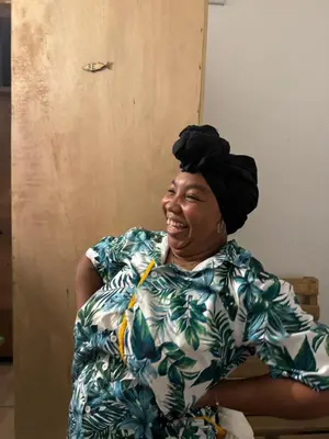 a woman sitting in a chair wearing a head scarf at Cabaña Punta Coral in Rincón