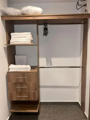 a closet with a wooden shelf and some towels at Apartamento Duplex en Barranquilla in Barranquilla