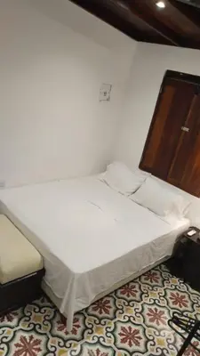 a white bed in a room with at Casa Belia in Cartagena de Indias