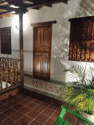 a room with a wooden door and a staircase at Casa Belia in Cartagena de Indias