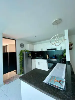 a kitchen with a magazine sitting on a counter at Casa Jardin in Cartagena de Indias