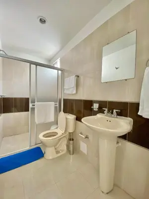a bathroom with a toilet and a sink at Casa Jardin in Cartagena de Indias