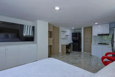 a large room with a kitchen and a living room at Lujoso Apartamento con salida a la playa in Cartagena de Indias