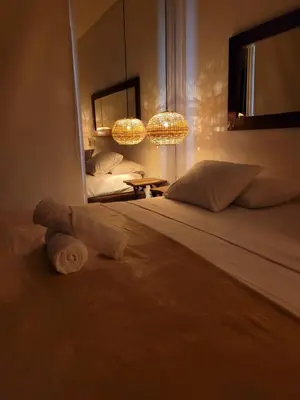 a bedroom with a bed and a mirror and lights at Apartamentos 129 Casa del Virrey Eslava Centro Histórico in Cartagena de Indias