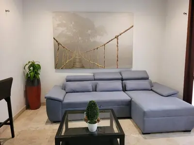 a living room with a blue couch and a bridge at Apartamentos 129 Casa del Virrey Eslava Centro Histórico in Cartagena de Indias