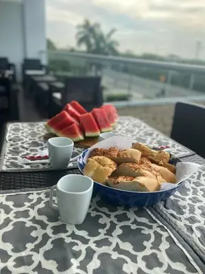 a plate of food on a table with two cups at Cartagena Apartamento en Morros en Primera Linea de PLaya in Cartagena de Indias