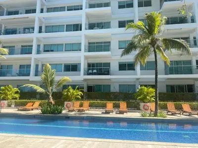 a hotel with a swimming pool in front of a building at Cartagena Apartamento en Morros en Primera Linea de PLaya in Cartagena de Indias