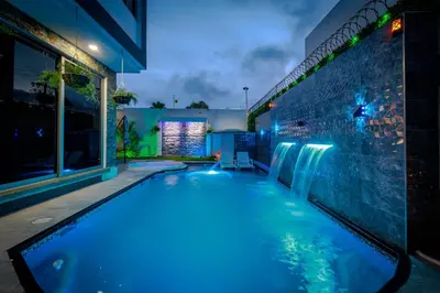 a swimming pool with blue lights in a building at Studio at the Resort Residence 2 in Puerto Colombia