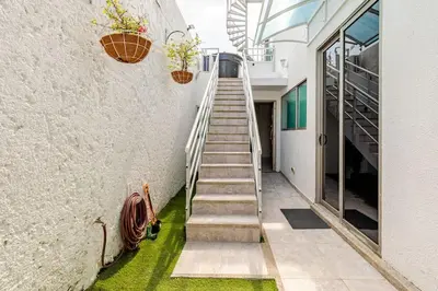a staircase leading up to a building with potted plants at Studio at the Resort Residence 2 in Puerto Colombia