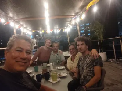 a group of people sitting at a table in a restaurant at Hotel Boutique - Casa Completa en Cartagena de Indias, barrio Castillogrande in Cartagena de Indias