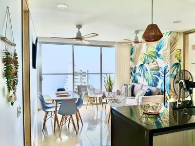 a living room with a table and chairs at Great sunsets & sea views, near beach&downtown in Cartagena de Indias