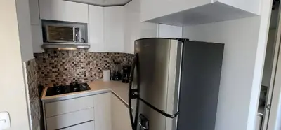 a kitchen with a stainless steel refrigerator and a microwave at Urbis 48 - Piso 23 in Cartagena de Indias