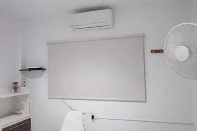 a white room with a fan on the wall at Maos flats-Habitacion comfort in Cartagena de Indias
