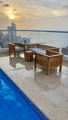 two benches sitting next to a pool on top of a building at Luxury Apartment In Bocagrande With Ocean View 502 in Cartagena de Indias