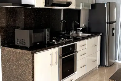 a kitchen with a microwave and a stove and a sink at Vacation Home Apartment in Cartagena in Cartagena de Indias