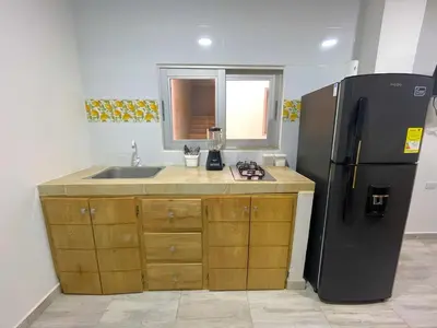 a kitchen with a refrigerator and a sink at Apartamento Villa Carolina 102 in Coveñas
