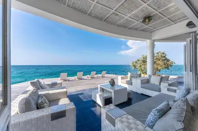 a patio with couches and the ocean in the background at Isla Matamba in Isla Grande