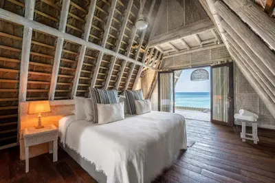 a bedroom with a bed with a view of the ocean at Isla Matamba in Isla Grande