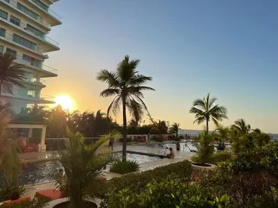 a resort with a pool and palm trees and a building at Morros 3 con salida al mar y Piscina in Cartagena de Indias