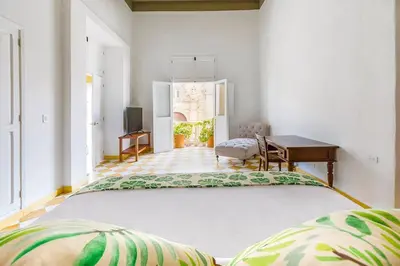 a large bed in a living room with a table at Casa en la mejor plaza de la ciudad vieja in Cartagena de Indias