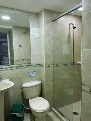 a bathroom with a toilet and a glass shower at Beach retreat in El Laguito in Cartagena de Indias