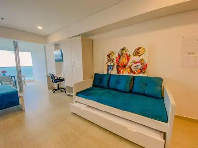a bedroom with a bed and a painting on the wall at Cartagena Suite Lujo Vista Mar 5 min Aeropuerto in Cartagena de Indias