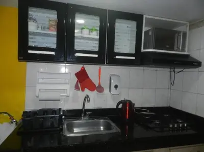 a kitchen with a sink and a stove and windows at la Ola de la Vida con AA WIFI in Cartagena de Indias
