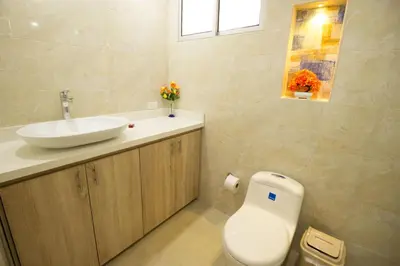 a bathroom with a white toilet and a sink at Caribbean Summer - Livin Colombia in Cartagena de Indias