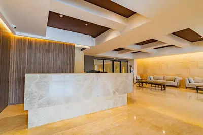 a lobby with a large marble counter in the middle at U-GO Vistas al Mar desde Murano Centro: Piscina, Jacuzzi y Más in Cartagena de Indias