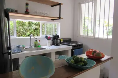a kitchen with a sink and a bowl of fruit on a counter at Casa Amin Tolu in San Silvestre