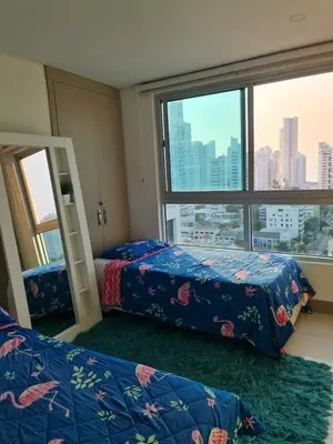 a bedroom with two beds and a large window at Beachfront Luxurious Apartment, Palmetto Beach in Cartagena de Indias
