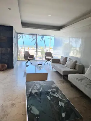 a living room with a couch and a table at Beachfront Luxurious Apartment, Palmetto Beach in Cartagena de Indias