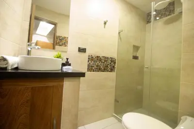 a bathroom with a sink and a shower at Riviera Sunrise Beach - Frente al mar y vista panorámica a toda la ciudad in Cartagena de Indias