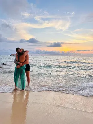 a man and a woman standing on a beach at Itaca Eco House in Playa Blanca