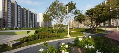 a park with flowers and trees and buildings at Encantador apartamento de diseño con hermosas vistas en Ciudad Mallorquín in Puerto Colombia