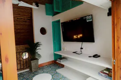 a living room with a tv on the wall at Spiritual Luxury 4BR Pool&Roofterrac Getsemani NEW in Cartagena de Indias
