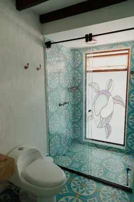 a bathroom with a toilet and a glass shower at Spiritual Luxury 4BR Pool&Roofterrac Getsemani NEW in Cartagena de Indias