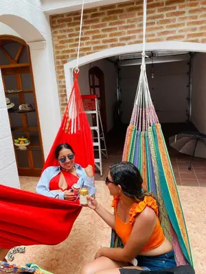 two women sitting in a hammock in a garage at Castillo de la Popa in Cartagena de Indias