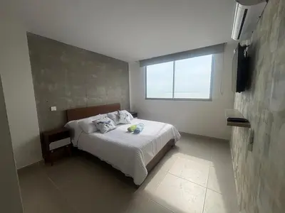 a bedroom with a bed and a window in it at Cartagena SUNNO BEACH in Cartagena de Indias