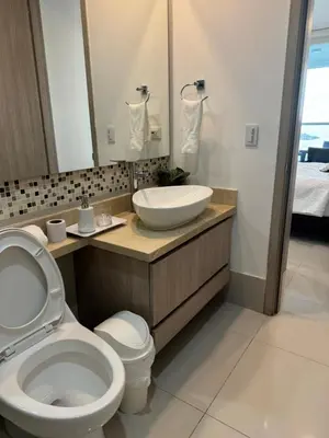 a bathroom with a white toilet and a sink at Palmetto Sunset 3204 in Cartagena de Indias