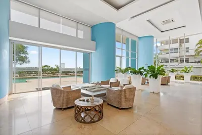 a living room with chairs and a table and windows at Palmetto Sunset 3204 in Cartagena de Indias