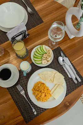 a table with plates of food on a wooden table at Casa Mishka Hotel Boutique Habitación #104 Nuevo Cartagena in Cartagena de Indias