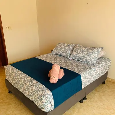 a bedroom with a bed with a towel on it at Hostel Cerca al Centro Histórico in Cartagena de Indias