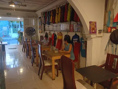 two people sitting at a table in a restaurant at Nahimara Champeta Hostel in Cartagena de Indias