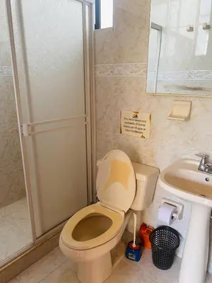 a bathroom with a toilet and a sink and a shower at Paraiso Pie de la Popa in Cartagena de Indias