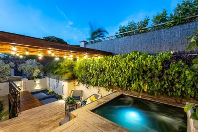 a backyard with a swimming pool and plants at Casa Santino Luxury Getsemaní-Cartagena in Cartagena de Indias